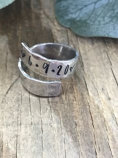 "This listing is for one 1/4\" wide 14 gauge aluminum wrap ring customized with your choice of name, date or short phrase. Please include in the message to seller section what you would like stamped on your ring up to 20 letters or numbers. Please also take note that it is not recommended to wear these rings in contact with water or any washing products to avoid the darkened letters to fade away. This lightweight aluminum adjustable wrap ring is 1/4 inches wide and is created from pure high grad Personalized Silver Engraved Ring For Mother's Day, Adjustable Wide Band Engraved Ring For Gift, Personalized Adjustable Open Ring, Customizable Silver Engraved Ring For Mother's Day, Unique Nickel-free Engraved Ring For Anniversary, Silver Hand Stamped Rings For Mother's Day, Unique Adjustable Engraved Ring For Anniversary, Silver Engraved Ring With Custom Name For Mother's Day, Adjustable Stamped Engraved Ring For Anniversary