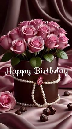 a birthday card with pink roses in a chocolate box and pearls on the bottom, surrounded by chocolates