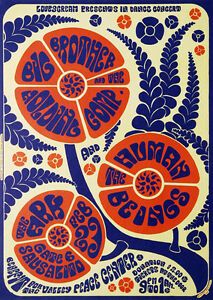 an orange and blue poster with flowers on it's back side, in the middle of