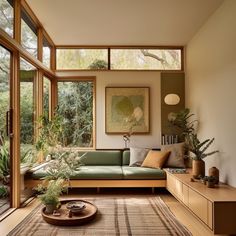 a living room filled with lots of furniture and plants on top of a wooden table