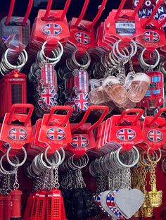 many different types of key chains and other items on display in a store window or shop