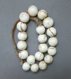 This strand round shell beads originates from Nepal. The hanging length of the strand is 26.5 cm. The average diameter of the beads is 2 cm.  Its weight is 245 gram.  (s27) SHIPPING SHIPMENT is FREE. All items are shipped every week on monday morning after receipt of payment. We send priority airmails. Please consider overseas shipments take usually 5 - 8 days. Insured packets (over 50 cm length / over 1500 gram) I send by standard way. PAYMENT Paypal is preferred.  RETURN POLICY: NO RISK: Any i Wooden Beads Round Necklace For Beach, Round Beaded Necklaces With Large Beads For Beach, White Wooden Beaded Necklaces, White Jewelry With Wooden Beads, White Jewelry With Round Wooden Beads, Hand-strung White Round Bead Necklaces, White Hand-strung Round Bead Necklaces, White Beaded Necklaces With Large Beads, White Beaded Necklace With Large Round Beads