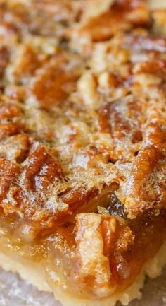 a close up view of some food on a piece of wax paper with other items in the background