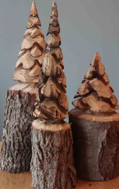 three small wooden trees sitting on top of a table