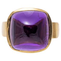 14k yellow gold ring. This lovely ring has a square sugarloaf cabochon cut dark purple color amethyst center, bezel set atop a modern profile, and wide, high polished yellow gold band. Marks: 14k Dimensions: 9/16" across the top x 1/2" wide Weight: 6.0 gross dwt Ring Size: 7 Yellow Gold Amethyst Ring, Amethyst Cocktail Ring, Dark Purple Color, Gold Amethyst Ring, Amethyst Set, Purple Amethyst Ring, Amethyst And Diamond Ring, Buckle Ring, Gold Cocktail Ring