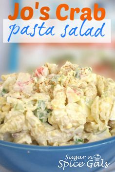 a blue bowl filled with pasta salad on top of a table