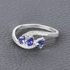 14K White Gold Tanzanite Ring, Genuine Tanzanite and Diamond Ring, Minimalist Tanzanite Ring, Dainty Tanzanite Ring, Bridesmaid Gift Sparkling tanzanite stones make this elegant bypass ring into something extra special. The bypass ring is crafted from 14k white gold with fine finish and definitely allows you to showcase your unique style amongst the crowd. With 0.51 carats, this ring has a subtle sparkle which makes it a clear winner! If you are looking for a unique, original, and affordable cho Tanzanite Birthstone Rings, Tanzanite Birthstone Promise Ring, Tanzanite Diamond Ring As A Gift, Tanzanite Three Stone Rings As A Gift, Three Stone Tanzanite Jewelry As Gift, White Gold Tanzanite Birthstone Promise Ring, Tanzanite Engagement Ring, Tanzanite Diamond Ring, Tanzanite Stone