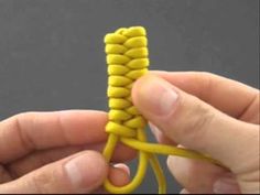 someone is holding a yellow piece of string