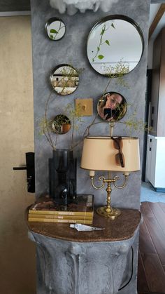 a table with a lamp and some mirrors on it