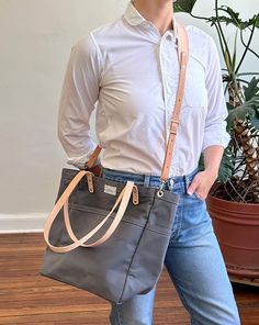 This versatile, fun tote is our best selling go-to for daily carry. Small batch handmade in our Omaha, NE studio using sturdy water repellent duck canvas and American full grain leather. WE ARE HANDMAKING MORE TOTES BUT THEY WILL NOT BE AVAILABLE UNTIL 12/20/2024. PLEASE USE OUR "NOTIFY ME" FEATURE (BELOW), AS WE'LL BE UPDATING THE SITE PERIODICALLY. ALSO, CONSIDER A GIFT CARD! Split Leg Apron, Tote Insert, Daily Carry, Canvas Leather Tote, Lunch Tote Bag, Tote Organization, Knitting Bag, Vintage Patches, Omaha Nebraska