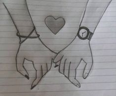 two hands holding each other with a heart on their wrist