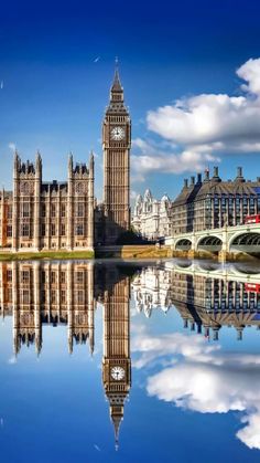 the big ben clock tower towering over the city of london reflected in the river thames