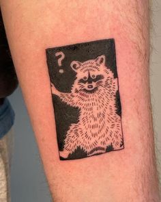 a raccoon with a question mark on it's arm