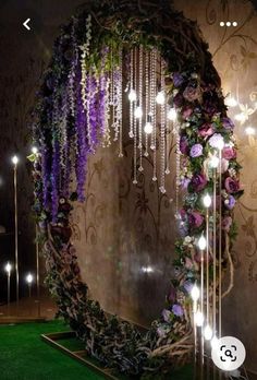 a circular mirror decorated with flowers and lights