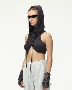 Details: Sleeveless top with hood and string designTop Length: CroppedSleeve Length: SleevelessMaterials:95% Polyester + 5% Spandex Fitted Top With Drawstring Hood For Streetwear, Sleeveless Top With Drawstring Hood For Spring, Sleeveless Tops With Drawstring Tie, Fitted Hooded Summer Tops, Black Sleeveless Top With Drawstring, Sleeveless Athleisure Top With Drawstring Hood, Fitted Sleeveless Top With Drawstring Tie, Stretch Drawstring Hood Tops For Streetwear, Stretchy Streetwear Top With Drawstring Hood