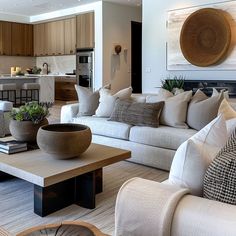 a living room filled with lots of furniture next to a kitchen and dining room table