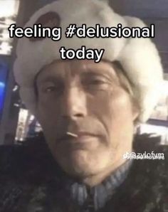 a man wearing a hat with the words feeling delusional today