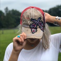 Red And Tan With Crossed Oistol Embroidery Front. Soft Red Mesh Back With Freedom Embroidered Velcro Strap Red Trucker Hat For Festival, Embroidered Red Hats, Casual Red Hat One Size, Red Embroidered Snapback Trucker Hat, Red Embroidered Snapback Hat, Red Bohemian Embroidered Hat, Casual Baseball Cap For Festivals, Casual Red Embroidered Hat, Red Embroidered Cap