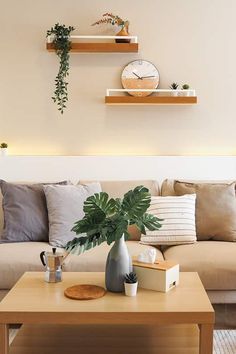 a living room with couches, coffee table and clock on the wall above it