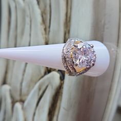 a diamond ring sitting on top of a white toothbrush