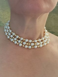 "The late Princess Diana Princess of Wales would have added this beautiful choker to her collection. This is an astounding heirloom piece! It would look stunning as a wedding choker or at a special event. Weighing 87.0 grams, this wonder is comprised of 64 round cream coloured Akoya cultured pearls with fair luster and thick nacre measuring approximately 9.00 - 9.5 mm in diameter and 62 round 14k yellow gold hollow beads measuring approximately 6.0mm in diameter. It has three 14k yellow gold spa Yellow Gold Beaded Pearl Necklace For Wedding, Yellow Gold Beaded Jewelry For Wedding, Yellow Gold Beaded Wedding Jewelry, Yellow Gold Round Beads Wedding Necklace, Single Strand Costume Jewelry Necklace For Wedding, Wedding Yellow Gold Beaded Pearl Necklace, Vintage Single Strand Jewelry For Wedding, Vintage Single Strand Wedding Jewelry, Elegant Yellow Gold Choker For Wedding