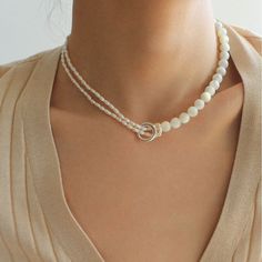 This stunning necklace features an elegant blend of 8mm natural white mother-of-pearl and delicate millet pearls, creating a chic half-and-half design that is both eye-catching and fashionable. With its sophisticated yet modern aesthetic, this piece brings an air of elegance and grace to any outfit. Whether paired with a dress, blazer, or knitwear, it adds a soft and refined touch, making it the perfect accessory for a variety of styles. Metal: Recycled Sterling Silver Plated On Brass Material: Freshwater Pearls/ 8mm White Mother-of-pearl Length: 330-390mm/33-39cm Elegant Pearl White Beaded Necklace With Pearl Pendant, Elegant Pearl White Necklace With Pearl Pendant, Chic White Pearl Jewelry, Pearl White Shell Necklace With Pearl Chain, Round Beads Pearl Necklace, Minimalist White Pearl Necklace With Charm, Minimalist White Beaded Pearl Necklace, White Mother Of Pearl Shell Necklace With Pearl Pendant, Elegant Polished Bead Necklaces