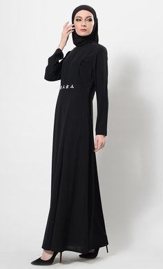 Featuring a beautiful modest wear flared asymmetrical abaya dress in nida fabirc adorned with crystal embellished motifs around the waist and pleated detailing on the upper bodice. It has flared bottom skirt, zipper closure placket at the back and pckets on the sides. Its a trendy and classic ensembl perfect to be worn for evening ocassions.FIT : Relaxed fit.COMPOSITION : Nida.CARE : Dry clean only. Modest Abaya With Modesty Panel For Spring, Spring Modest Abaya With Modesty Panel, Long Sleeve Abaya With Modesty Panel For Fall, Fall Long Sleeve Abaya With Modesty Panel, Spring Abaya With Modesty Panel, Fitted Black Abaya For Eid, Formal Modest Abaya For Fall, Modest Formal Abaya For Fall, Formal Maxi-length Abaya For Fall