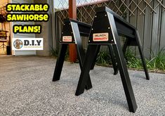 two black tables with stickers on them sitting in front of a building