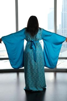 Luxuriate in this fabulous blue silk kimono wrap dress with beautiful complementary satin wide sleeves, excitingly unique & flattering on your figure > Buy now! Silk Robe With Kimono Sleeves For Party, Silk Party Robe With Kimono Sleeves, Silk Kimono Robe For Party, Elegant Kaftan With Bell Sleeves, Elegant V-neck Festive Kimono, Silk Evening Kimono With Kimono Sleeves, Flowy Silk Long Sleeve Kimono, Evening Kimono With Kimono Sleeves, Evening Bohemian Kaftan With Kimono Sleeves