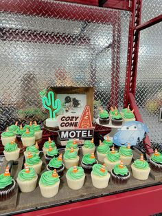 cupcakes are arranged on a table in front of a sign that says cone motel