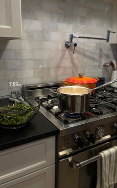 a stove top oven sitting next to a pot filled with food