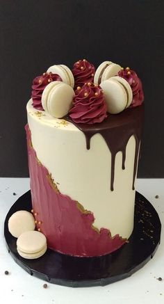 a cake with white and red icing on it