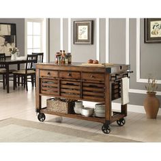 a kitchen island cart with baskets on it