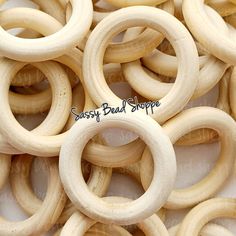 several wooden rings are arranged together on a white surface with the words sassy bad shoppe written above them