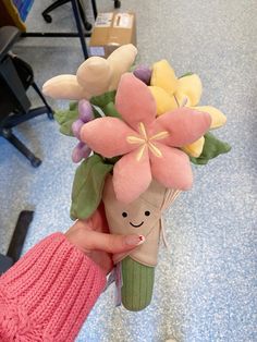 a person holding a bouquet of flowers in their hand