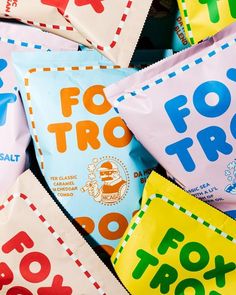 many different types of candy bags stacked on top of each other, with the words fox trot printed on them