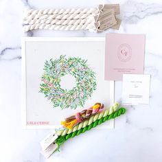 a cross stitch pattern and some craft supplies on a table with the letter o in it