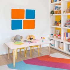 a child's playroom with toys and bookshelves