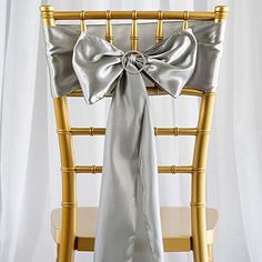 a chair with a silver bow on it