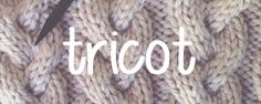 there is a knitted object with the word triot written in white on it