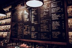 a large menu on the wall behind a bar