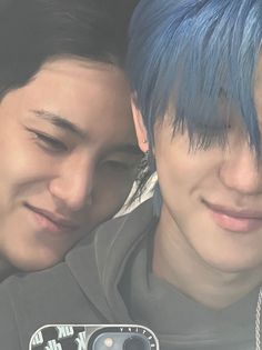 two people with blue hair taking a selfie