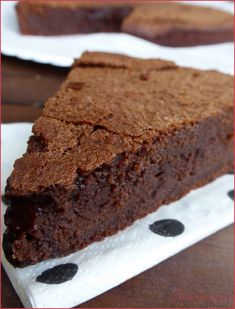 a piece of chocolate cake sitting on top of a white plate