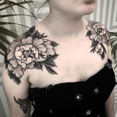 a woman with black and white flowers on her chest