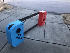 two blue and red boxes sitting on the sidewalk