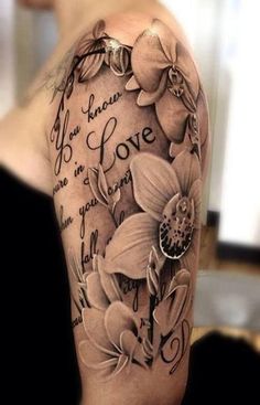 a woman's arm with flowers and words on it