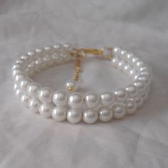 WARM PROMPT: The correct measurement of the length of the bracelet is:the length of the wrist +0.5-1 inch = the length of the bracelet. Welcome back to my shop: https://www.etsy.com/shop/pearlandjewelry Description of the product in the picture: I make the two Strands Pearl bracelet with 6mm ivory glass pearls , They use golden accessories.The bracelet lengh is 7.5 inches,IT has a 2 inch long adjustable chain,It is nice for your wedding. The picture color is ivory. Can choose other colors are:iv White Pearl Drop Bracelets For Wedding, White Beaded Bracelet With Pearl Chain For Wedding, White Pearl Chain Bracelet For Wedding, Adjustable Pearl Wedding Bracelet, Classic Adjustable Beaded Bracelets For Wedding, White Round Pearl Bracelet For Wedding, Ivory Necklace, Pearl Bridesmaid Jewelry, Pearl Bracelet Wedding