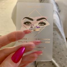 a close up of a person holding a business card with eyeliners on it