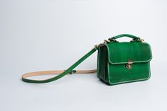 "Product Description * Material: vegetable tanned leather * Color: Hand-dyeing green * Flap over entry with buckle closure ,a rounded projection on the, please press it down to open the flap * One interior divider * 0.75\" wide leather shoulder strap adjust from 36.61\" to 44.88\" * Sewn by hand; * Size: 150mm (H) x 200mm (W) x 90mm (D) / 5.9\" x 7.8\" x 3.5\" Please first look at the production process of our product. 1. The vegetable tanned leather is made in Italy: Vegetable tanning is an anc Green Leather Satchel As Gift, Green Satchel Saddle Bag For Travel, Green Top Handle Shoulder Bag With Leather Lining, Green Soft Leather Shoulder Bag Gift, Green Rectangular Briefcase For Everyday Use, Classic Green Briefcase For Everyday Use, Green Handmade Everyday Satchel, Green Satchel Saddle Bag With Adjustable Strap, Classic Green Bag As Gift