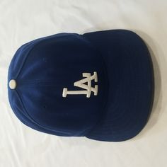 La Dodger Hat. Mens. One Size Fitted Hat 7 1/4 (57.7 Cm). Color Blue And White. Fabric Stretching/ Wear Inside, See Photos. Brand New Era Classic Curved Brim Hats For Sports Events, Classic Blue Baseball Cap With Flat Brim, Classic Blue Snapback Fitted Hat, Classic Blue Snapback Hat, Classic Blue Adjustable Snapback Hat, Classic Blue Flat Brim Baseball Cap, Classic Adjustable Blue Fitted Hat, Classic Blue Baseball Cap For Baseball Season, Classic Blue Baseball Cap